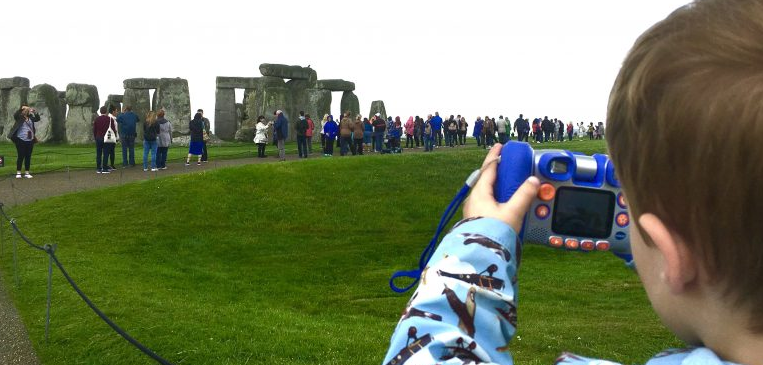 Young boy picturing Stonehenge on a visit