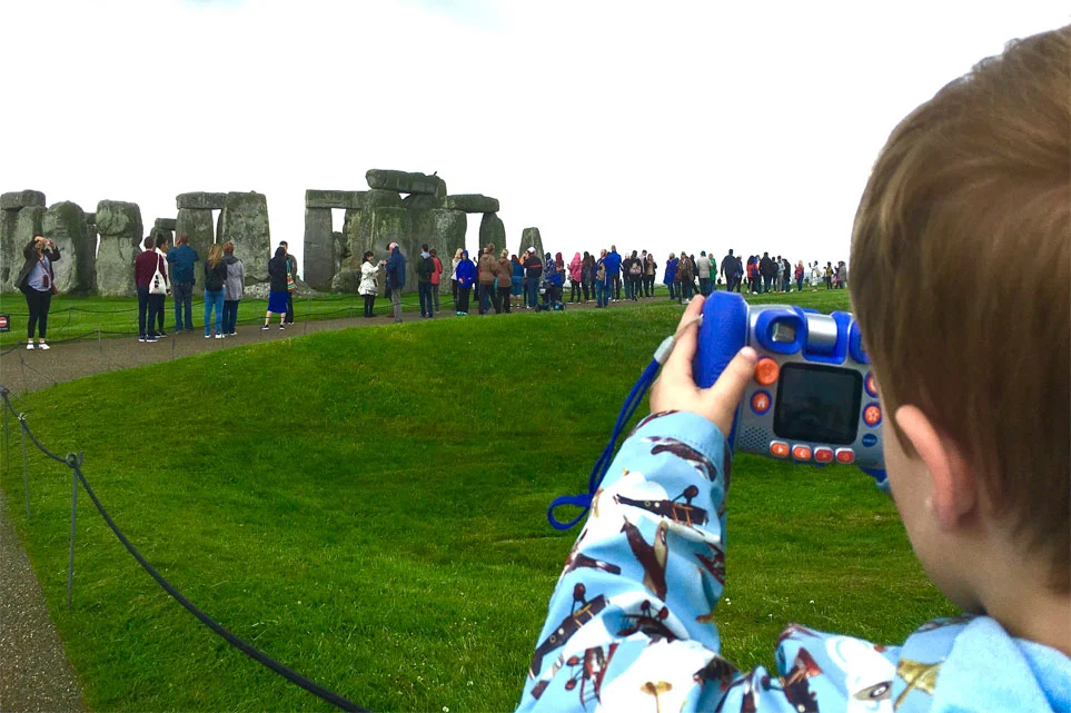 Young boy picturing Stonehenge on a visit